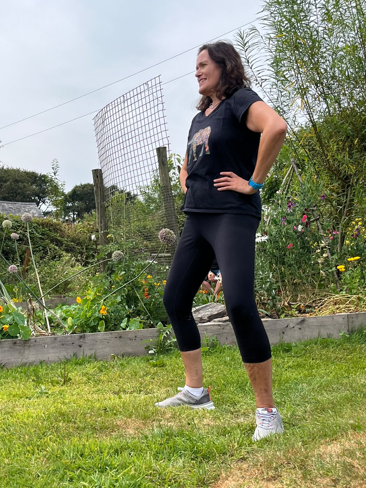 Jyoti demonstrating standing movement outdoors